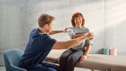 Professional Sport Physiotherapy Specialist Stretching and Working on Specific Muscles, Shoulder Joints with Elderly Woman. MIddle Aged Female Recovering from Mild Injury, Undergoing Rehabilitation.