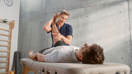 Professional Sport Physiotherapist Working on Muscle Groups or Joints with Young Male Athlete. Sportsman Recovering from Injury. Trauma Prevention Therapy or Rehabilitation. Healthcare Concept.