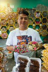 Vertical photo of a Latino man seller of traditional handmade sweets from Masaya Nicaragua