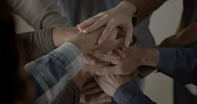 A group of businesspeople joining their hands in solidarity