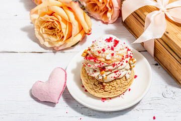 The concept of romantic gift. French Shu cake, hibiscus tea, bouquet of roses, festive decor