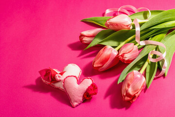 Greeting concept flower composition, a bouquet of pink tulips, and hearts
