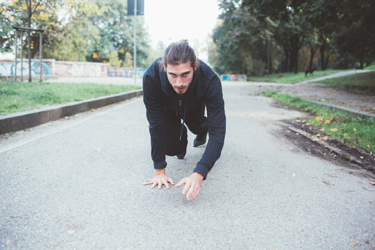 Athletic sportive man training outdoors crawling
