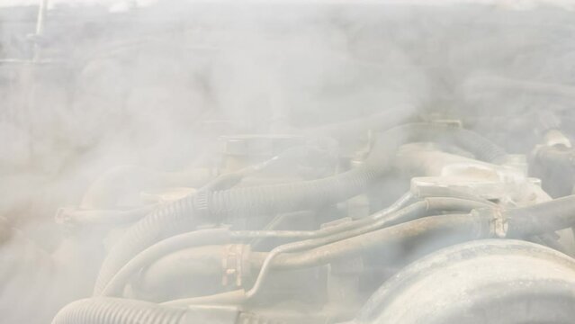 Smoke coming out the broken car engine