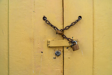 chain lock on the wooden yellow door. copy space