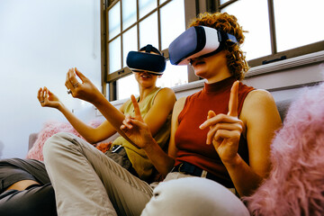 Female couple wearing VR headsets
