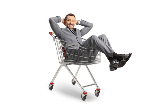 Young Professional Man Sitting Inside A Shopping Cart