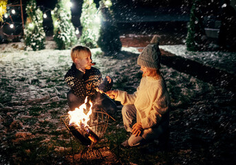 Kids with sparklers having fun on night outdoor party