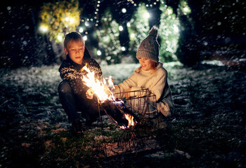 Fototapeta na wymiar Kids with sparklers having fun on night outdoor party