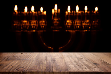 religion image of empty wooden table in front of jewish holiday Hanukkah background with menorah...