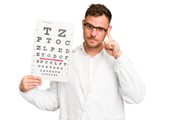 Young caucasian oculist man isolated pointing temple with finger, thinking, focused on a task.