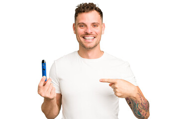 Young caucasian man holding a electronic cigarette isolated person pointing by hand to a shirt copy...