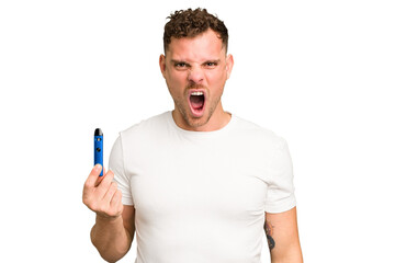 Young caucasian man holding a electronic cigarette isolated screaming very angry and aggressive.