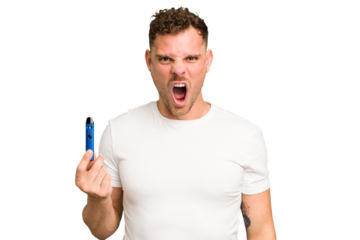 Young caucasian man holding a electronic cigarette isolated screaming very angry and aggressive.