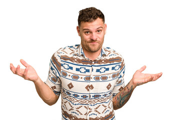 Young caucasian handsome man isolated doubting and shrugging shoulders in questioning gesture.