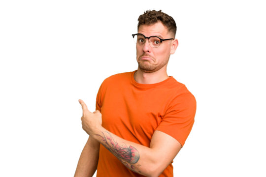 Young caucasian handsome man isolated smiling and pointing aside, showing something at blank space.