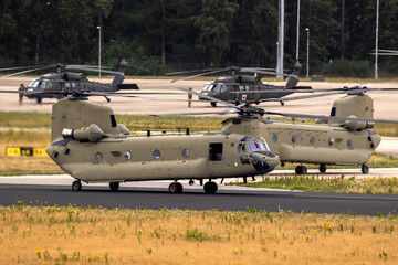 Various American army helicopters at an army air base