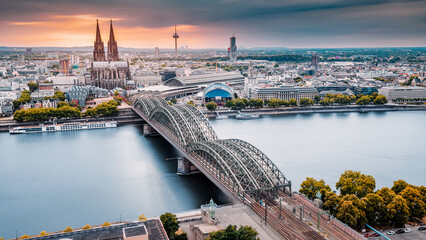 Cologne Aerial view with trains move on a bridge over the Rhine River on which cargo barges and...