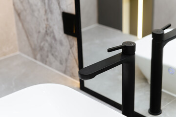 black metal bathroom faucet with mirror