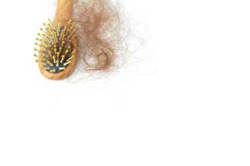Brown hair loss and comb, hair loss every day, serious problems and hair loss on a white background.	