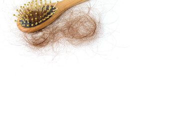 Brown hair loss and comb, hair loss every day, serious problems and hair loss on a white background.	