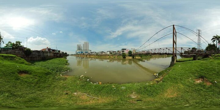 Polluted Ciliwung river with garbage in the slums of Jakarta, Indonesia. 360 panorama VR.