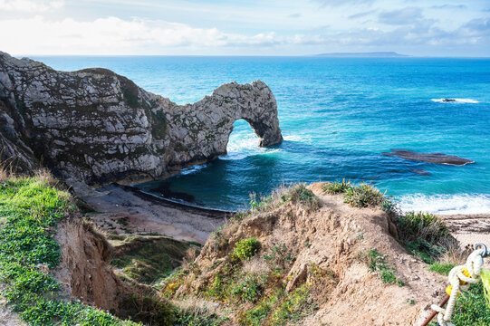 Views of natural rock formations Durdle door in Lulworth, Dorset, United Kingdom. Part of Jurassic Coast World Heritage Site, view of stone arch and blue sea, selective focus