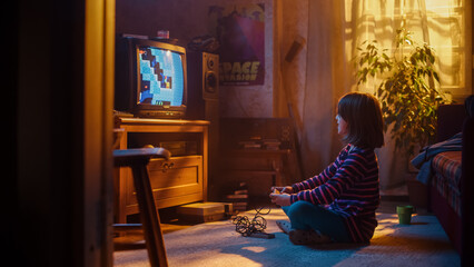 Nostalgic Retro Concept: Young Girl Playing Old-School Nineties Arcade Video Game on a Console at Home in Her Vintage Room with Period-Correct Interior. Kid Passes the Level with Flying Colors.