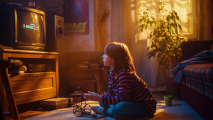 Nostalgic Childhood Concept: Young Girl Playing an Old-School Arcade Video Game on a Retro TV Set at Home in a Room with Period-Correct Interior. Kid Waiting For Level to Load.