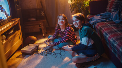 Home Video Concept: Young Brother and Sister Playing Old-School Arcade Video Game on a Retro TV Set...