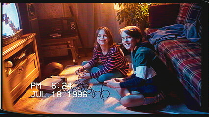 Retro VHS Tape Effect Home Video Concept: Young Brother and Sister Playing Old-School Arcade Video...