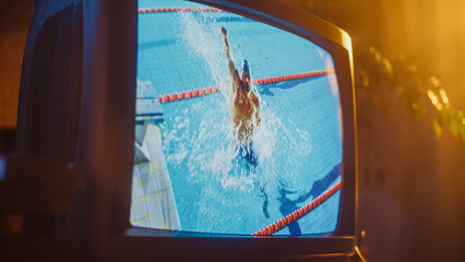 Close Up Footage of a Retro TV Set Screen with Live Sports Swimming Competition Broadcast. Athletic...