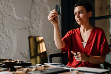 European woman working with tablet computer and interior samples
