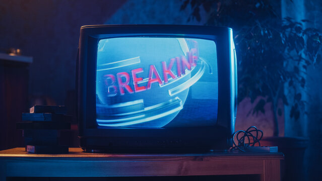 Close Up Footage of a Dated TV Screen. Breaking News Report Starting. Intro with Word Breaking Revolving Around Digital Earth on Vintage Display. Nostalgic Retro Nineties Technology Concept. - Powered by Adobe