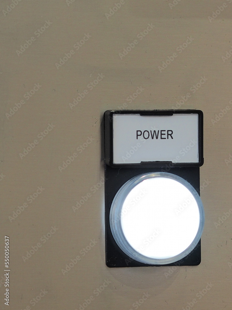 Wall mural Illuminated and labelled power button on a machine - Wall murals