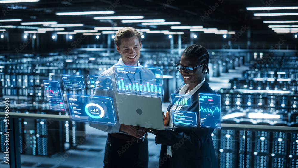 Poster Technical Engineer and Project Administrator Using Computer in Modern Data Center Server Room Facility. Augmented Reality Productivity and Business Data Icons Appear From Worker's Laptop.