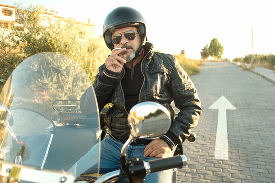 Mature man in sidecar smoking and posing looking at camera