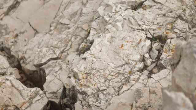 Slow motion and an aerial footage of a white stone texture of cliffs in Croatia.