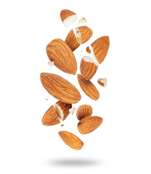Whole and crushed almonds close-up in the air on a white background
