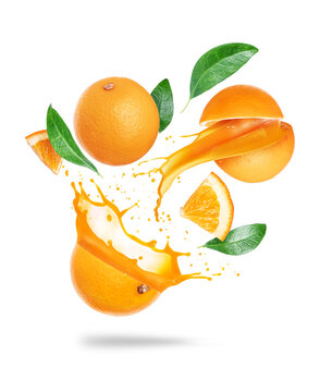 Whole and sliced oranges with juice splashes in the air isolated on a white background