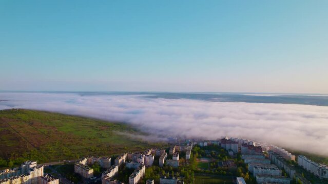 Drone footage of a modern suburb shrouded in morning fog. High resolution video. 4K.