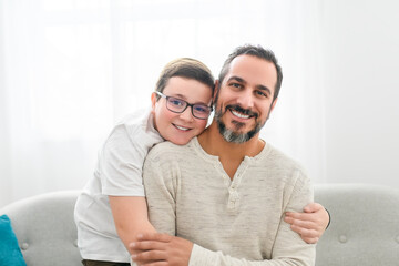 father and boy having great time on sofa at home