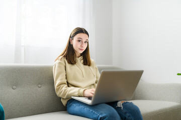 teen girl checking social media on laptop at home