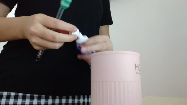 Women are squeezing toothpaste