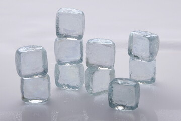 Ice cubes in a stack against a white background