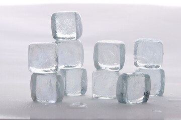 Ice cubes in a stack against a white background