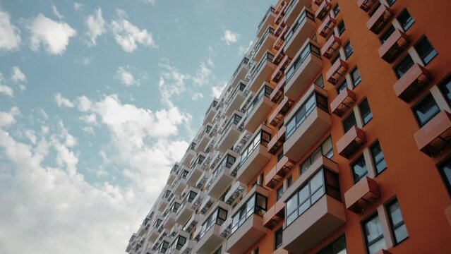 The movement of clouds in the sky against the backdrop of a high-rise residential building. Timelapse 