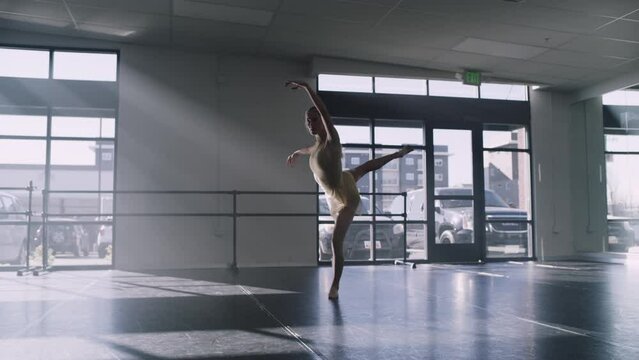 Distant woman practicing contemporary dancing in dance studio / Lehi, Utah, United States