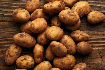 Potatoes on wooden planks food still life background