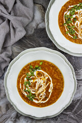 Lentil soup. Turkish cuisine traditional dish with red lentils, onions and carrots. Tomatoe spicy soup with vegetables and spices. Healthy vegetarian food.